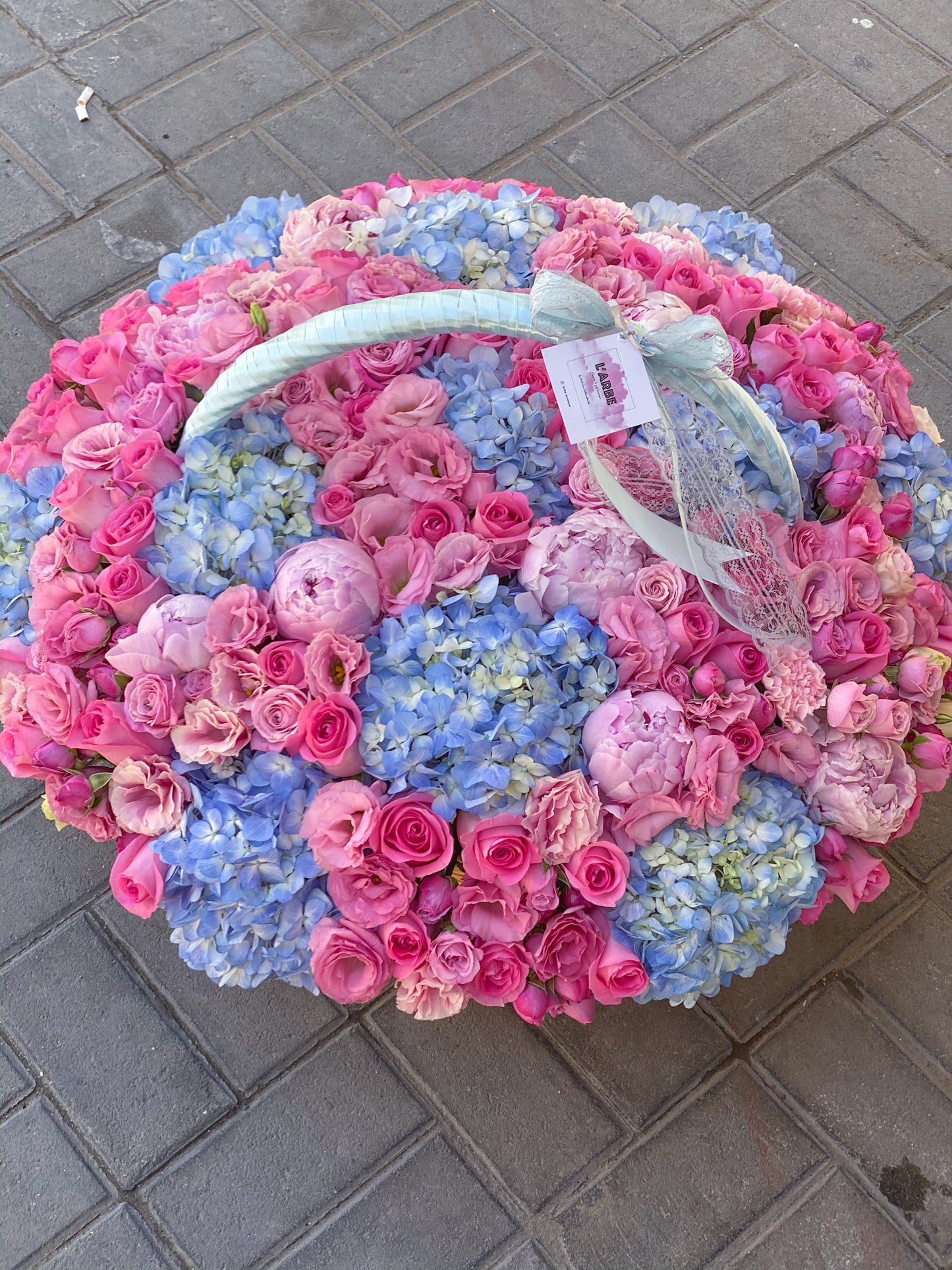PINK AND BLUE FLOWERS BOUQUET IN BASKET WITH HYDRANGEA AND ROSES