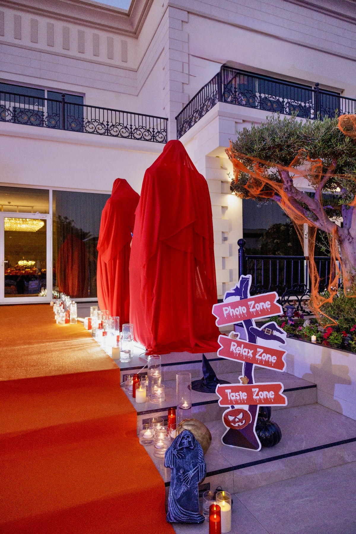 Crimson Ghosts Luxury Halloween Welcome Area with Red Draped Figures & Candlelit Walkway - rent