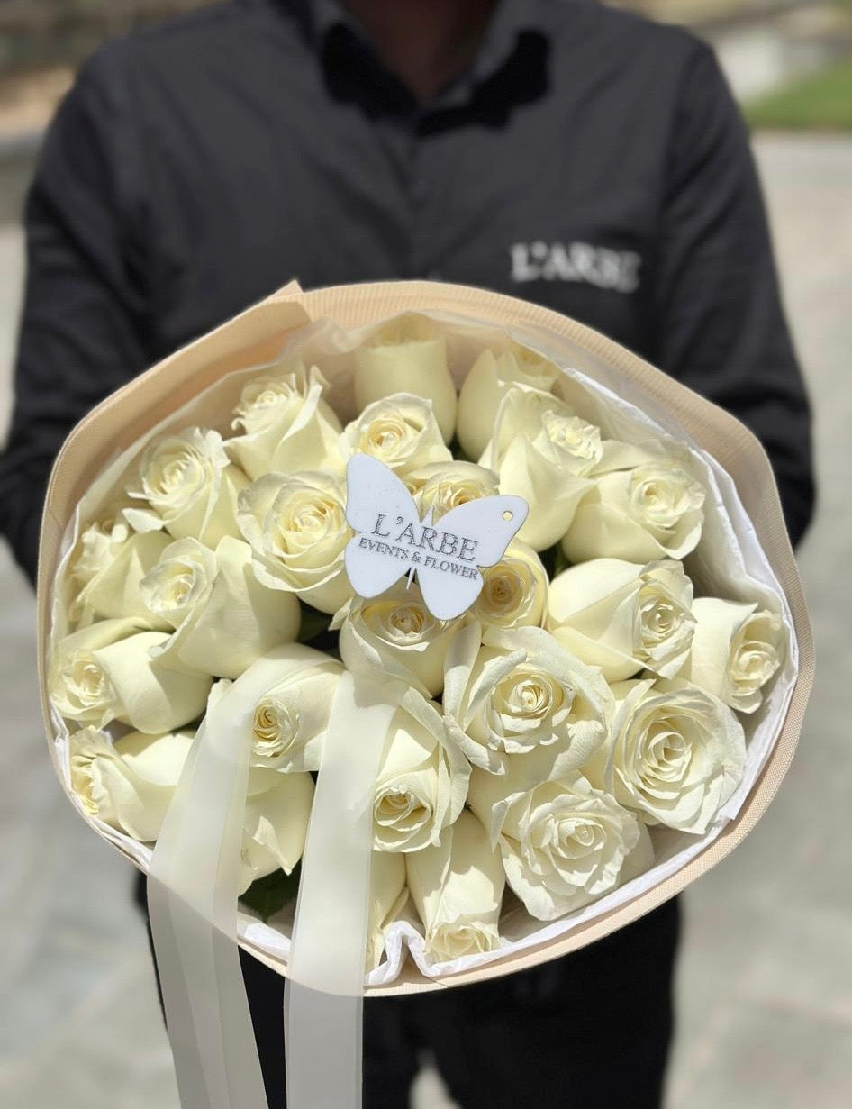 25 white roses in cream wrapping (colour can be changed)