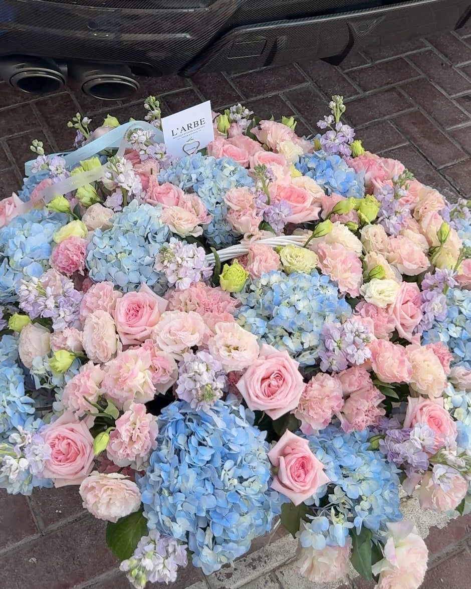BLUE AND PINK FLOWERS BOUQUET IN BASKET WITH HYDRANGEA AND ROSES