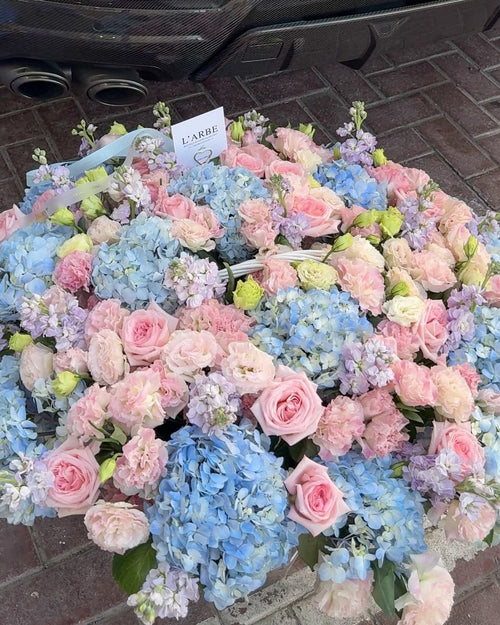 BLUE AND PINK FLOWERS BOUQUET IN BASKET WITH HYDRANGEA AND ROSES