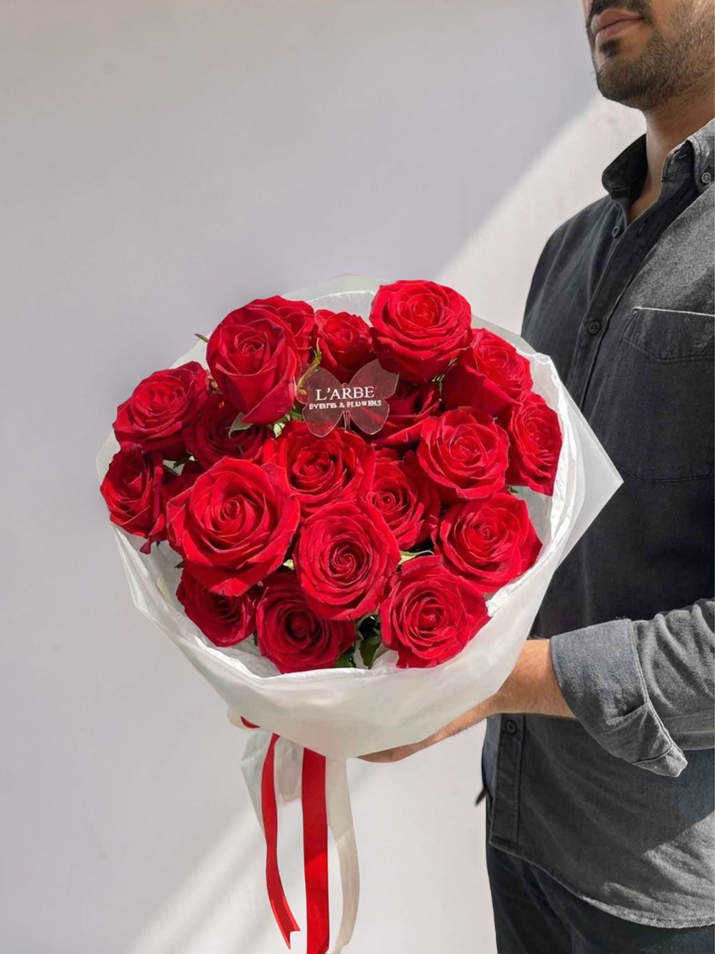 RED FLOWERS BOUQUET WITH ROSES IN WHITE WRAPPING 19 PCS