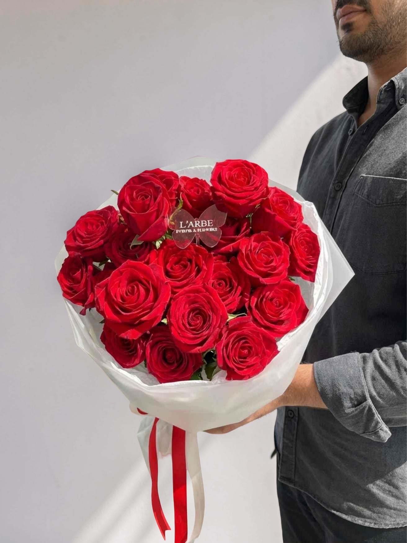 RED FLOWERS BOUQUET WITH ROSES IN WHITE WRAPPING 19 PCS