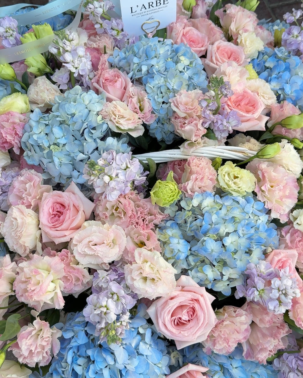 BLUE AND PINK FLOWERS BOUQUET IN BASKET WITH HYDRANGEA AND ROSES