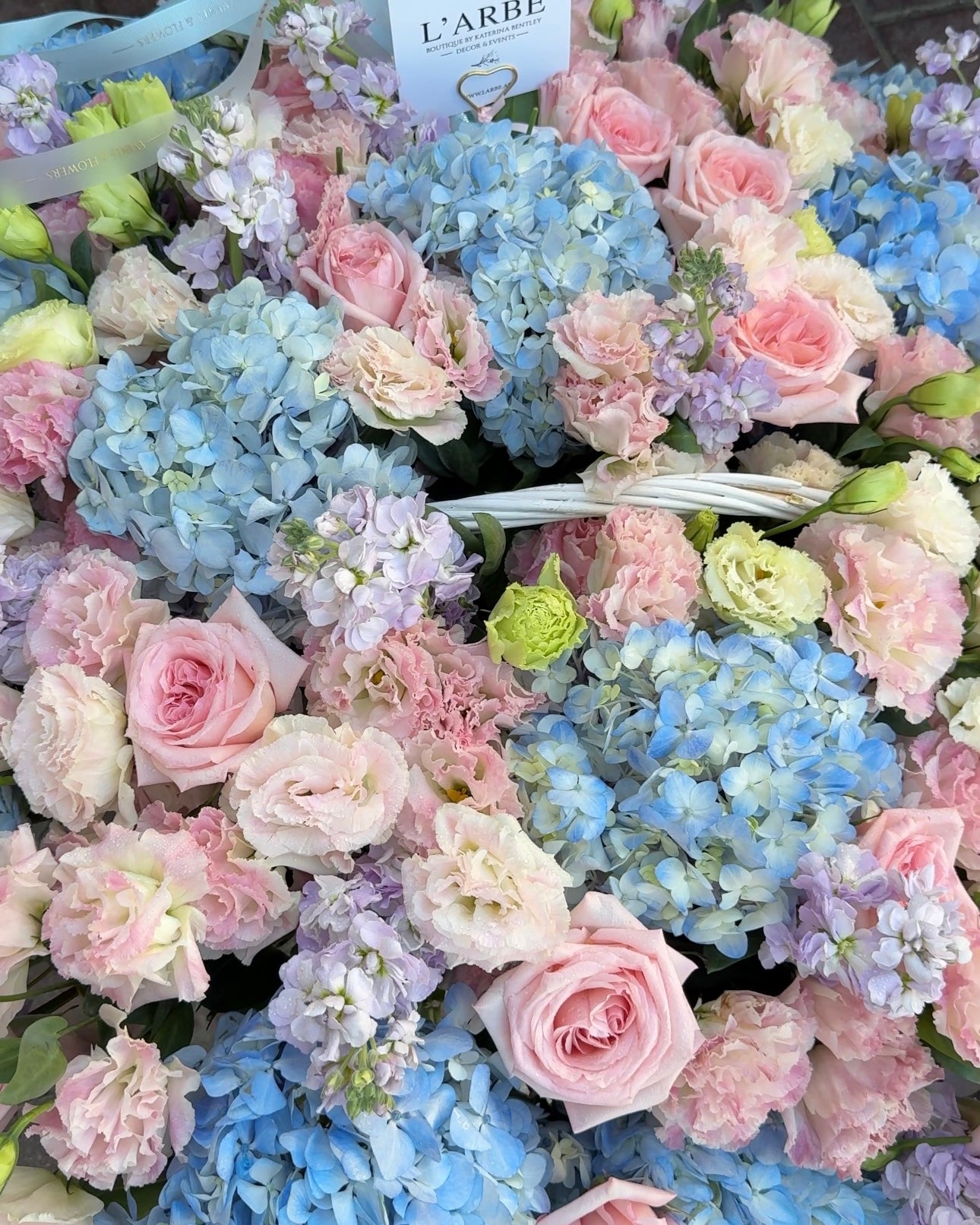 BLUE AND PINK FLOWERS BOUQUET IN BASKET WITH HYDRANGEA AND ROSES