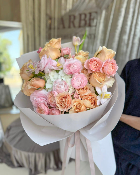PINK AND PEACH FLOWERS BOUQUET IN BASKET “HERSCHEL” WITH PEONIES, ROSES, MATTHIOLA AND VIBURNUM OPULUS