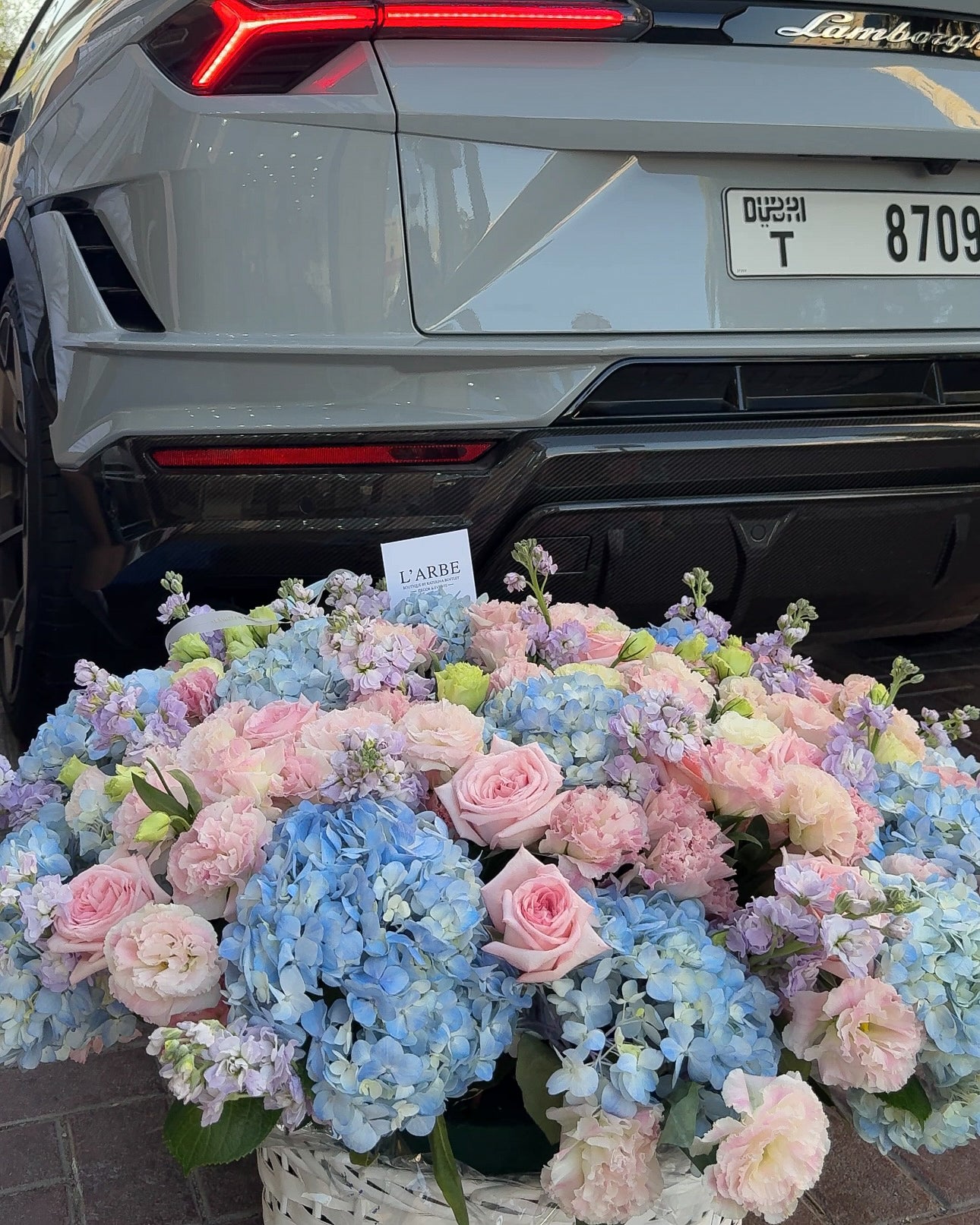 BLUE AND PINK FLOWERS BOUQUET IN BASKET WITH HYDRANGEA AND ROSES
