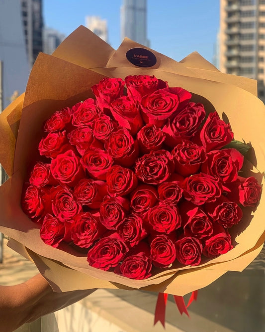 45 red roses in beige wrapping