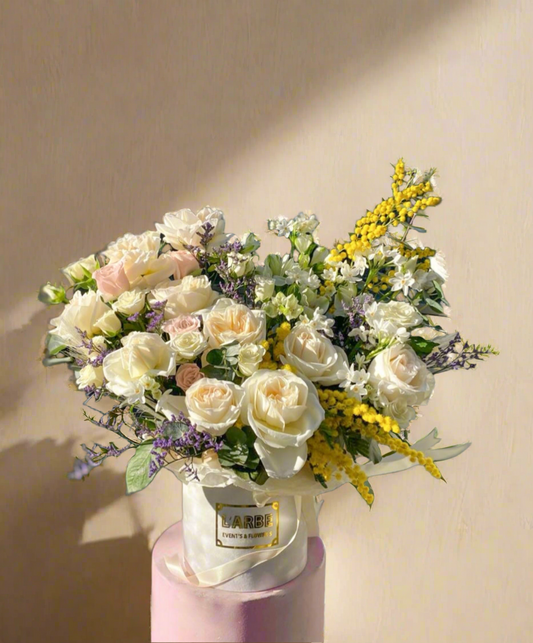 Box of flowers with mimosa and daffodil