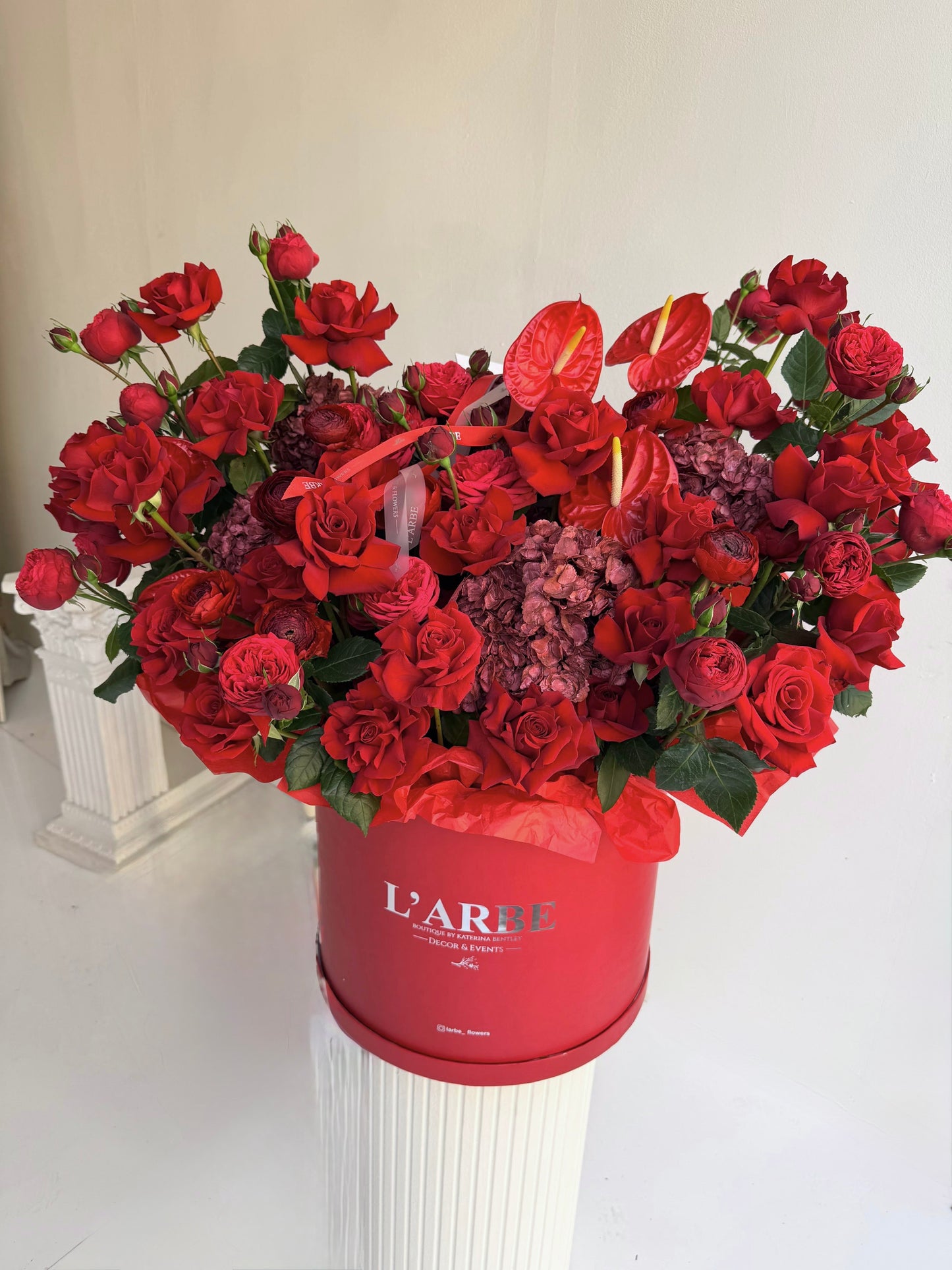 RED BOX WITH RED HYDRANGEAS AND ROSES “EMBRACE”
