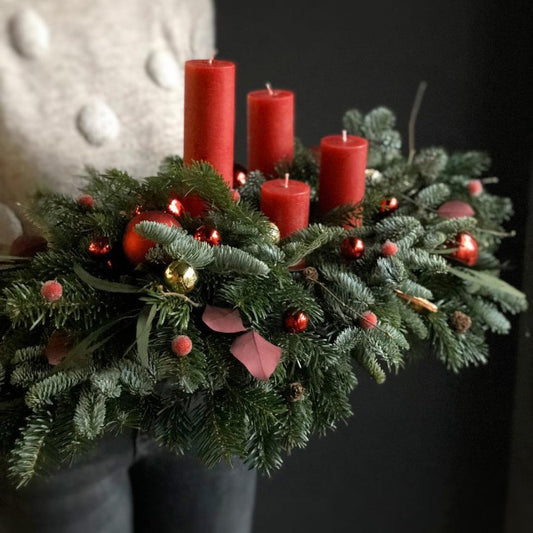 New Year centerpiece with red candles fresh nobilis